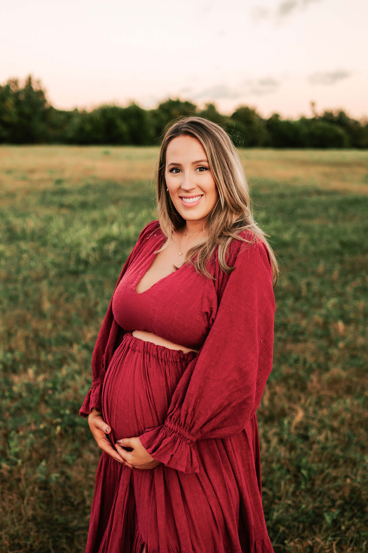 close up of pregnant mom in red dress maternity photography in Springfield MO