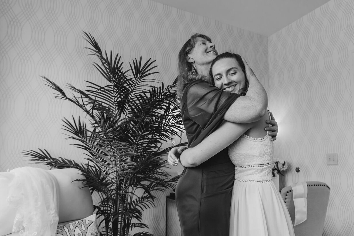 a parent hugging their child on their wedding day 
