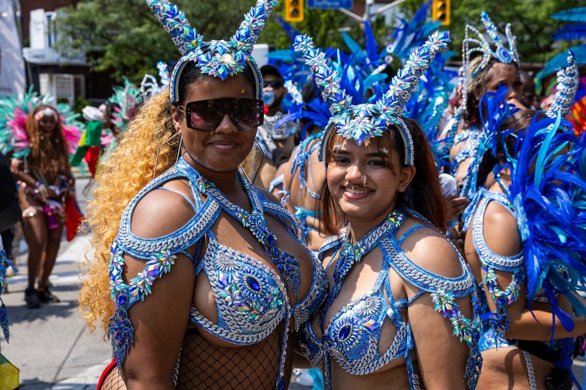 Toronto caribbean carnival parade masqueraders having fun in costume with Sunlime Mas, the number 1 medium size band at Toronto Carnival.