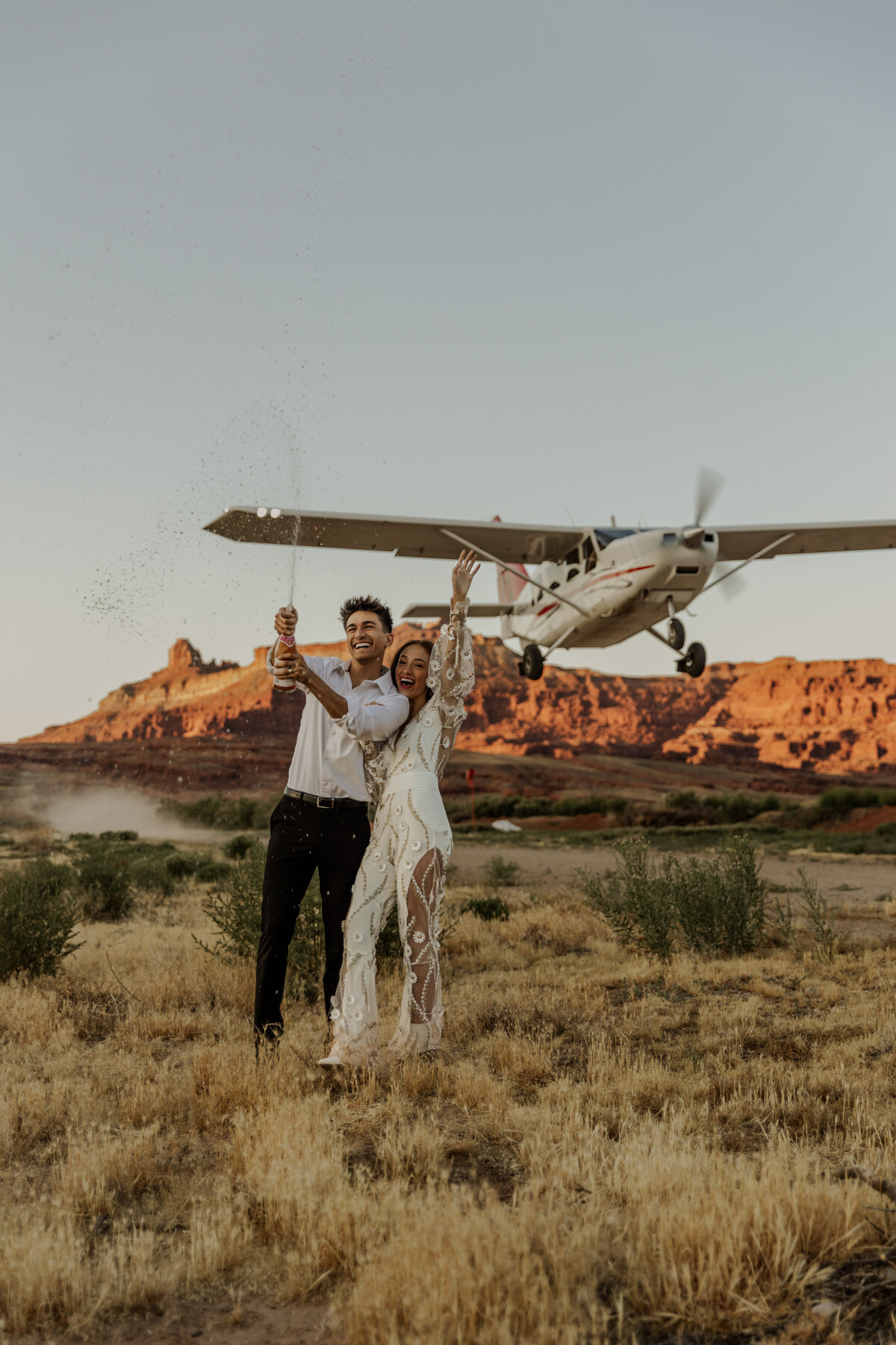 Champagne pop in front of a plane taking off in Moab, Utah 