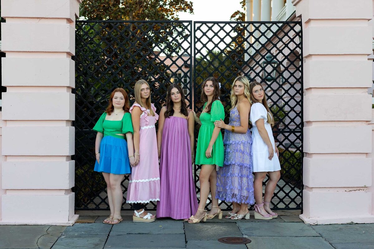 MBP Senior Team standing in front of a gate leaning against each other in Lawrence, KS