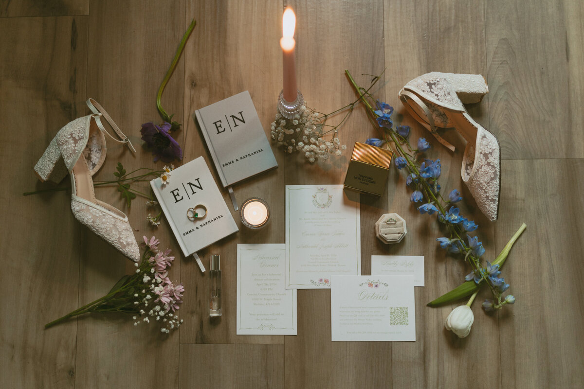 A beautifully arranged wedding flat lay featuring delicate details such as invitations, rings, floral accents, and other accessories, showcasing the sophisticated and personal touches of the couple's big day.