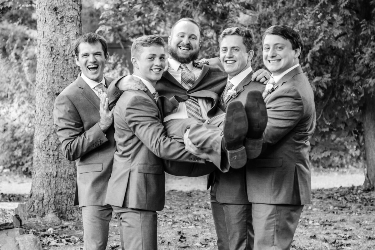 Groom carried by his groomsmen at Fosters Clambake in York Maine
