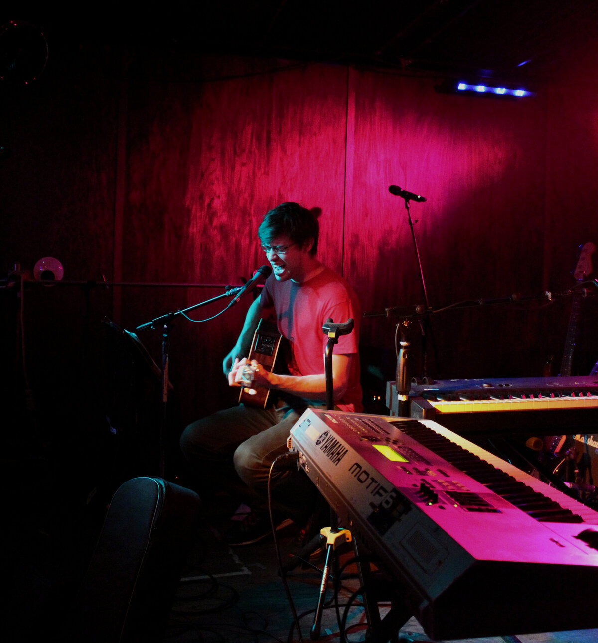 Nick Depuy live photograph playing guitar and singing