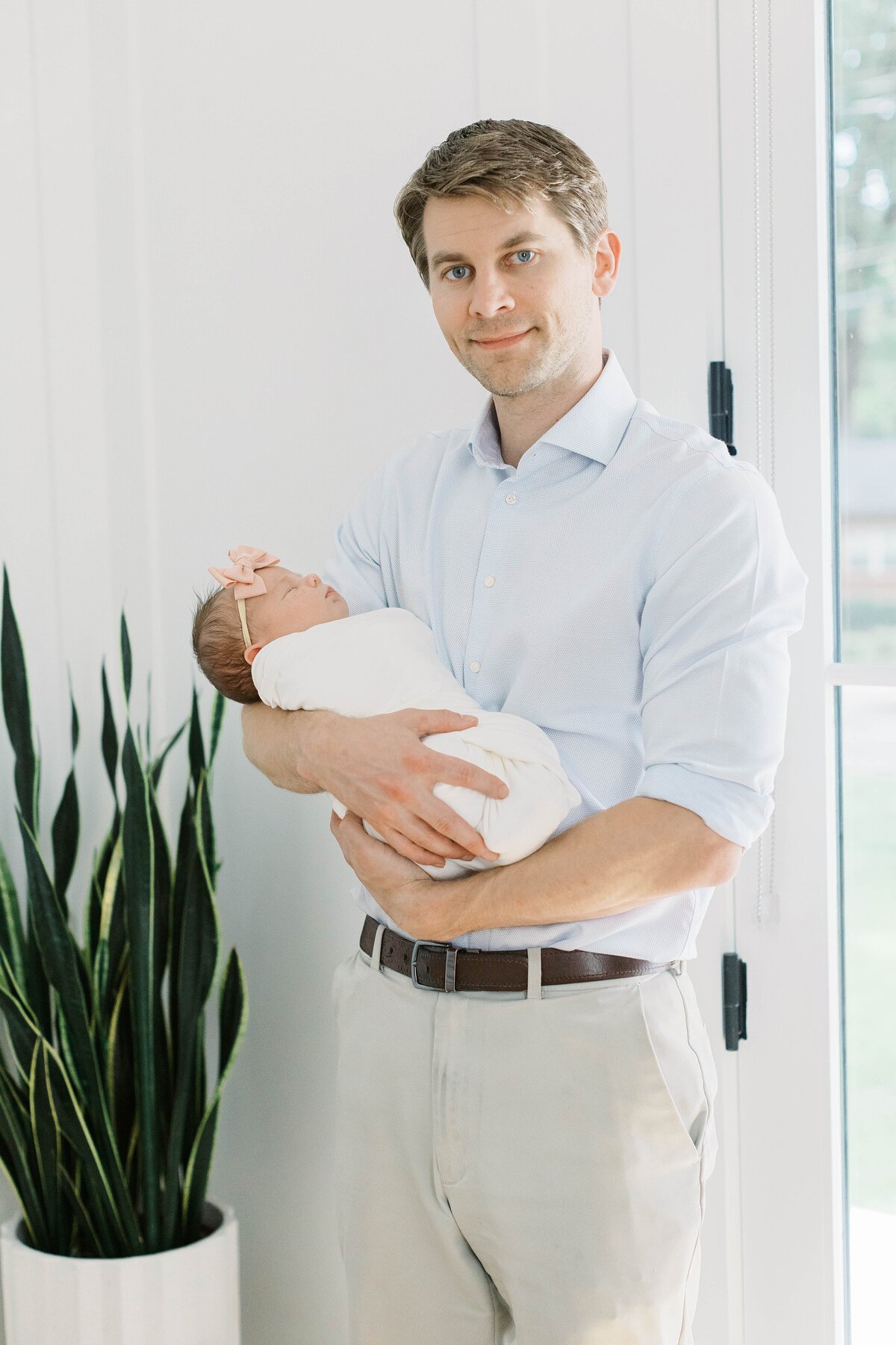 dad holding newborn baby girl