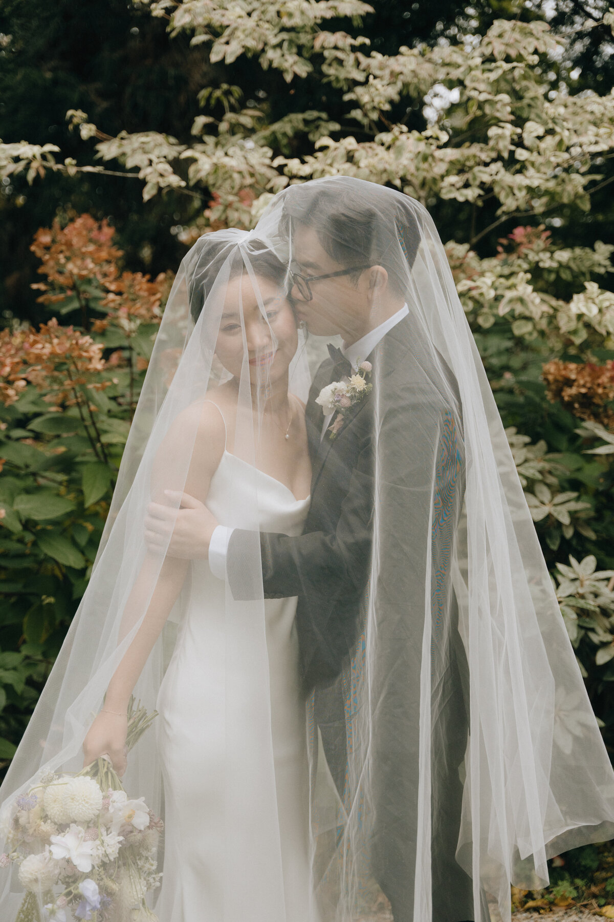 couple embracing under the veil at JM Cellars wedding