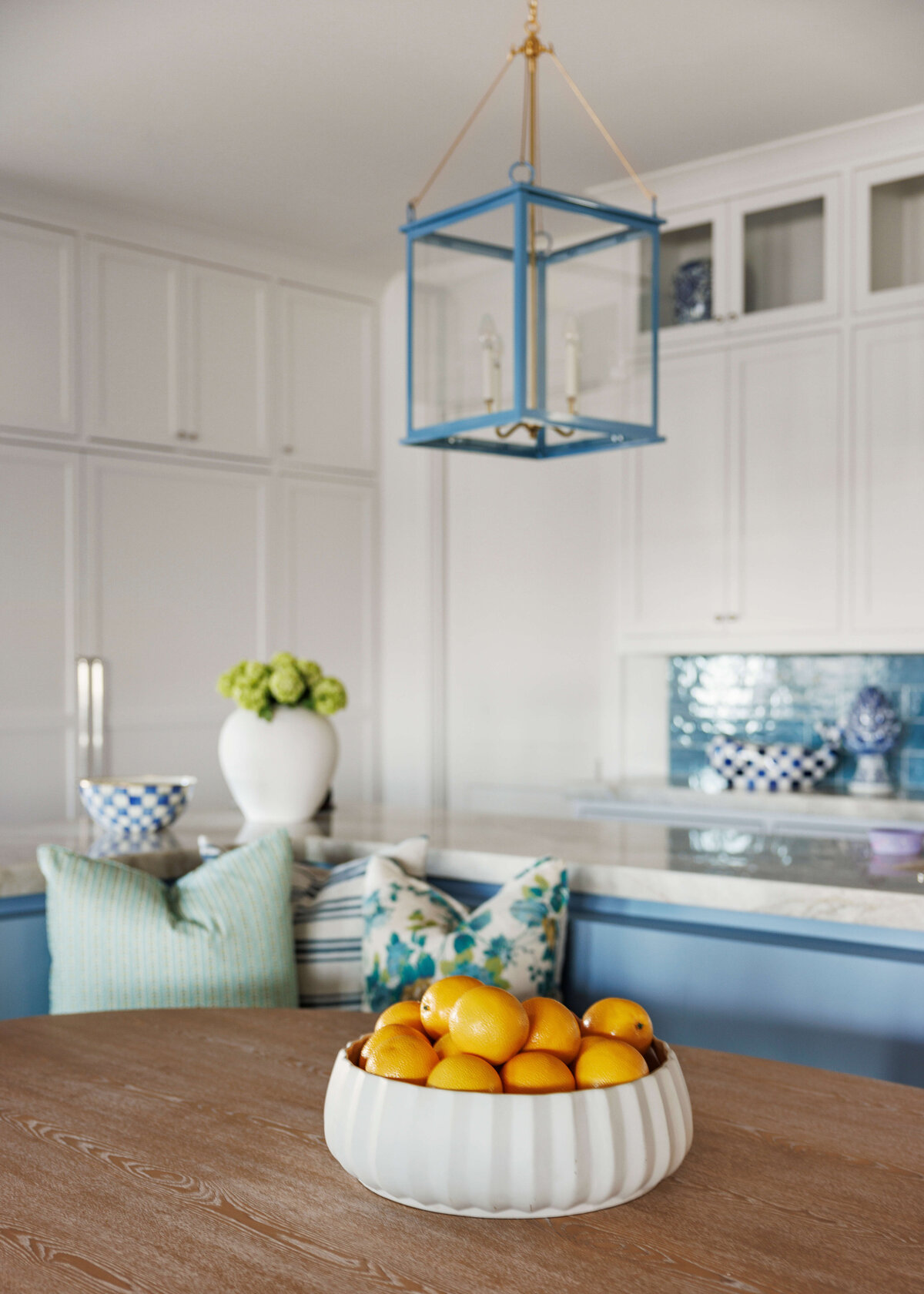 oyster creek studios lighthouse on the lake white cabinets with blue bench around kitchen table