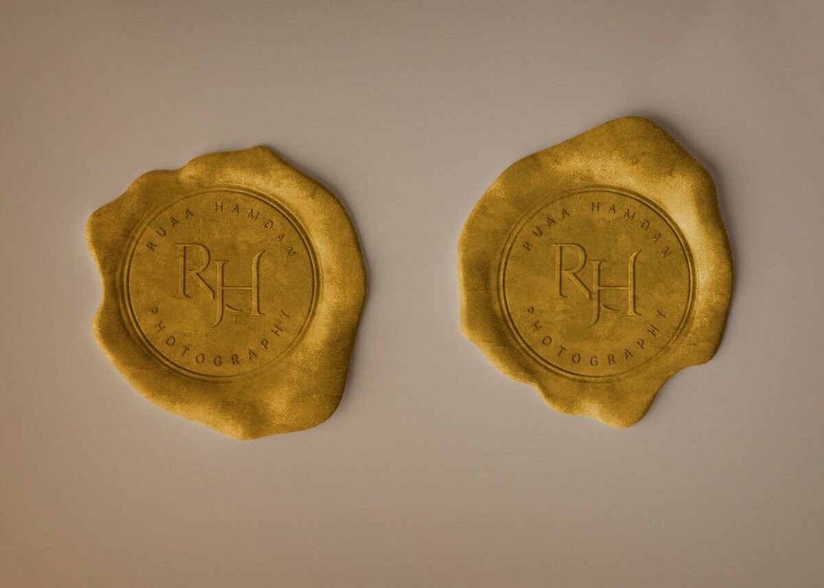 Two golden wax seals with embossed initials “RH” and the words “Photography,” set against a soft neutral background.