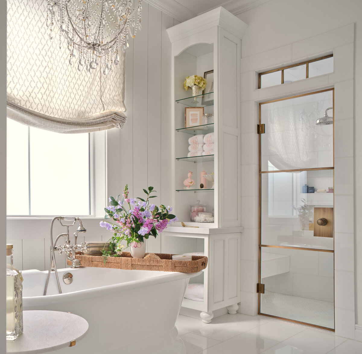 bathroom with floor bathtub and shelving