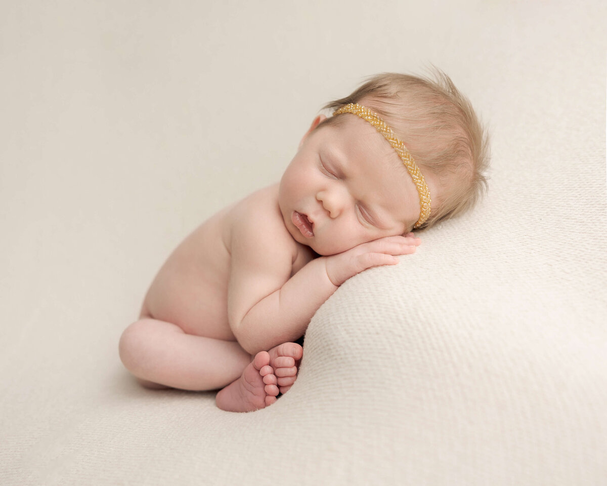 baby girl with blonde hair and gold headband on for portland baby pictures