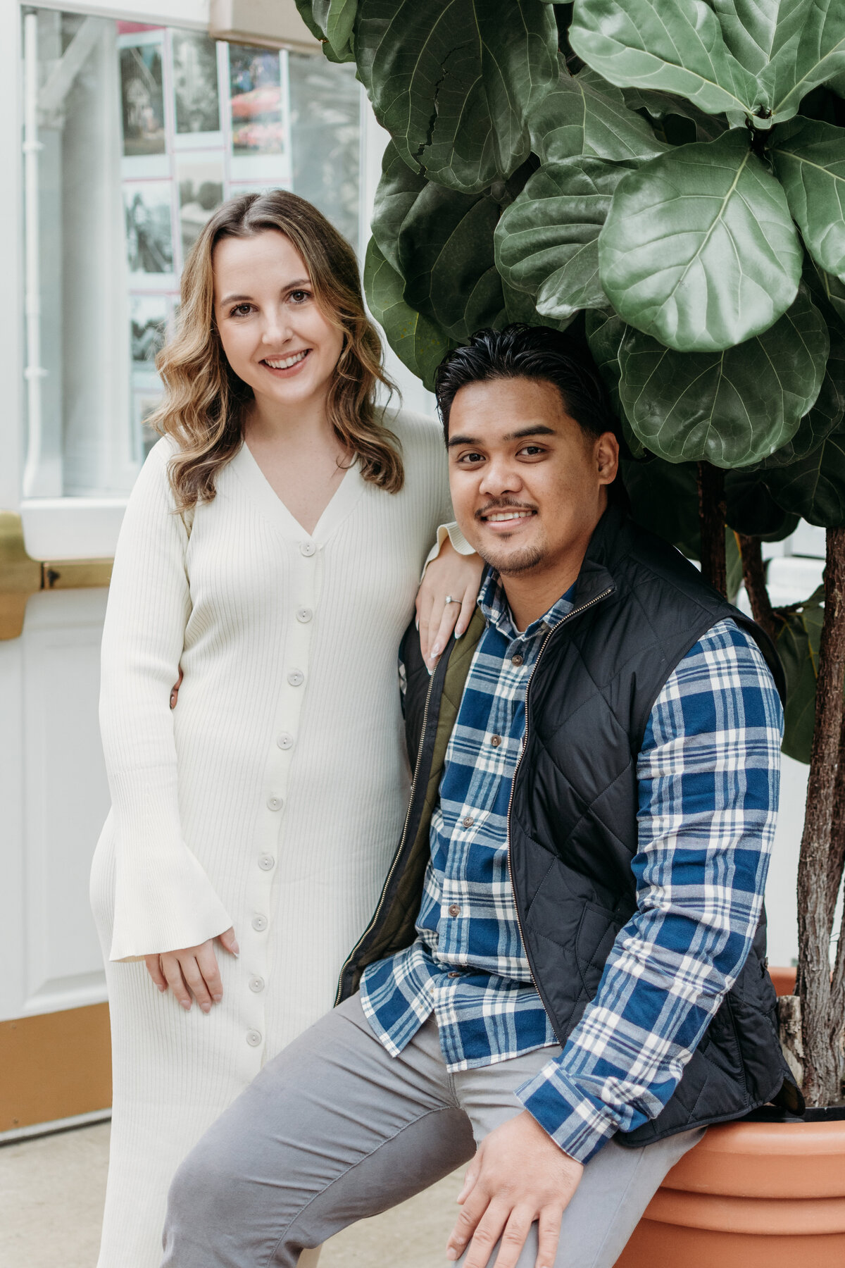 Winter engagement in a conservatory surrounded by lush greenery in Elmhurst, IL