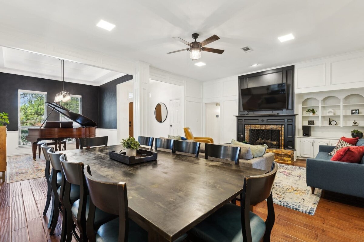 10216_shadow_way_dallas_tx_open_concept_dining_living_room_with_fireplace_and_piano_room_view_-_haven_realty_group