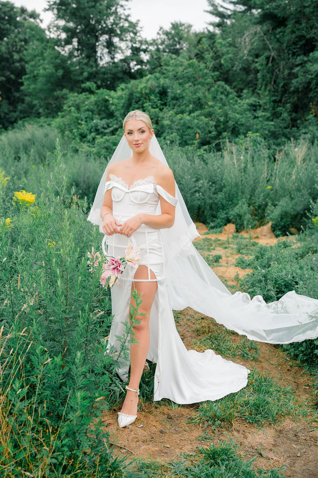 Elegant wedding gown featuring detachable sleeves and dramatic blusher veil
