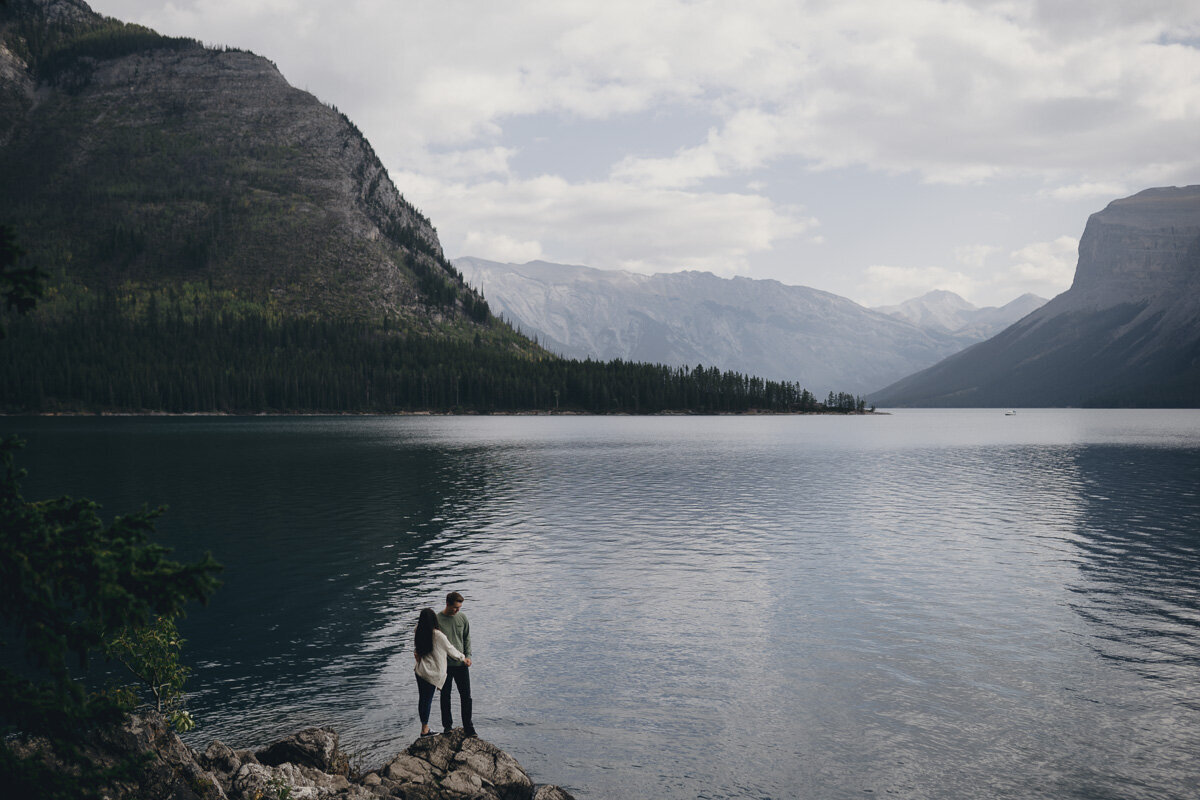 Adventurous couple on rocks at lake minndwanka
