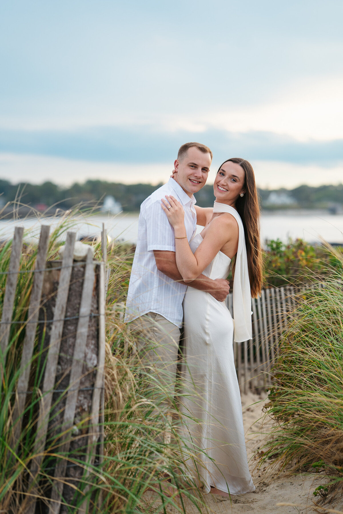 Romantic coastal engagement session in New England overlooking the shoreline.