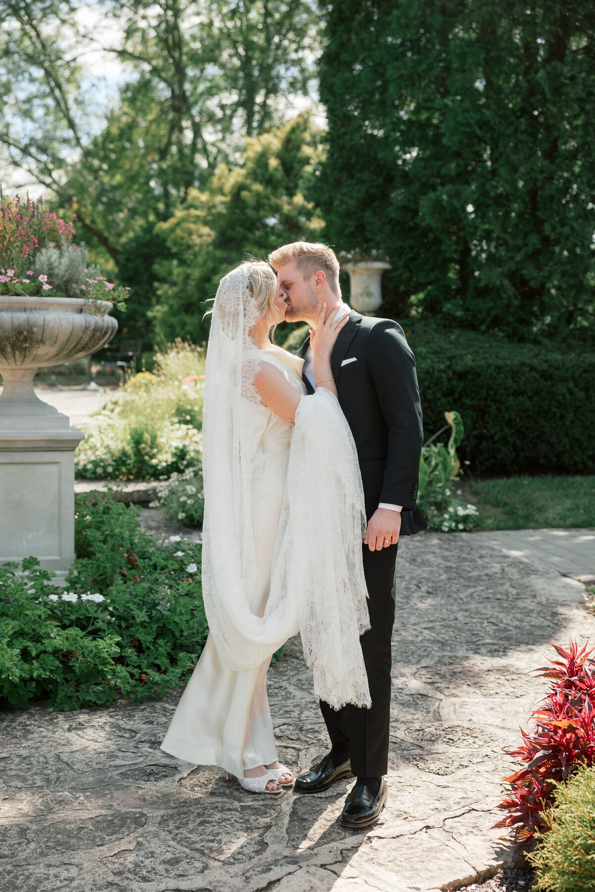 Romantic newlywed kiss in Dayton garden, wedding shot by Philadelphia-based photographer Olivia Casey.