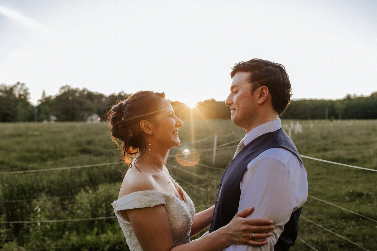 Serbian wedding: Couple outside during sunset with the sun going down behind them