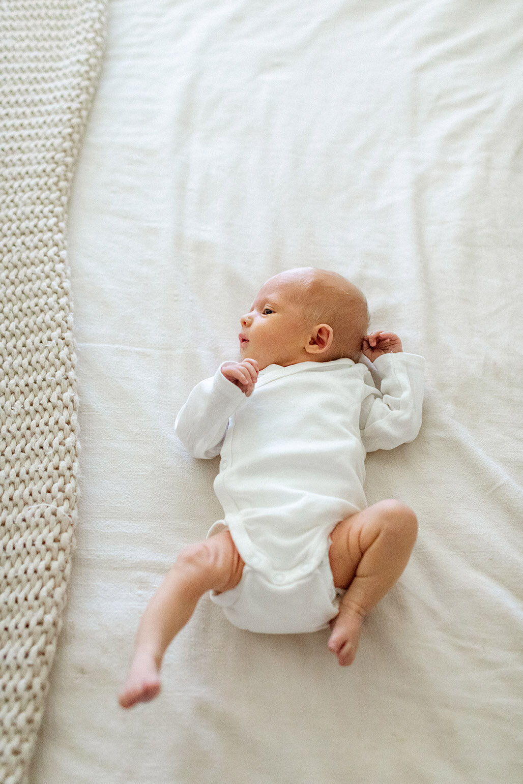 Newborn baby resting in nursery crib - Sara James captures peaceful infant sleep and nursery lifestyle moments during tranquil newborn photography sessions in San Antonio Texas family homes