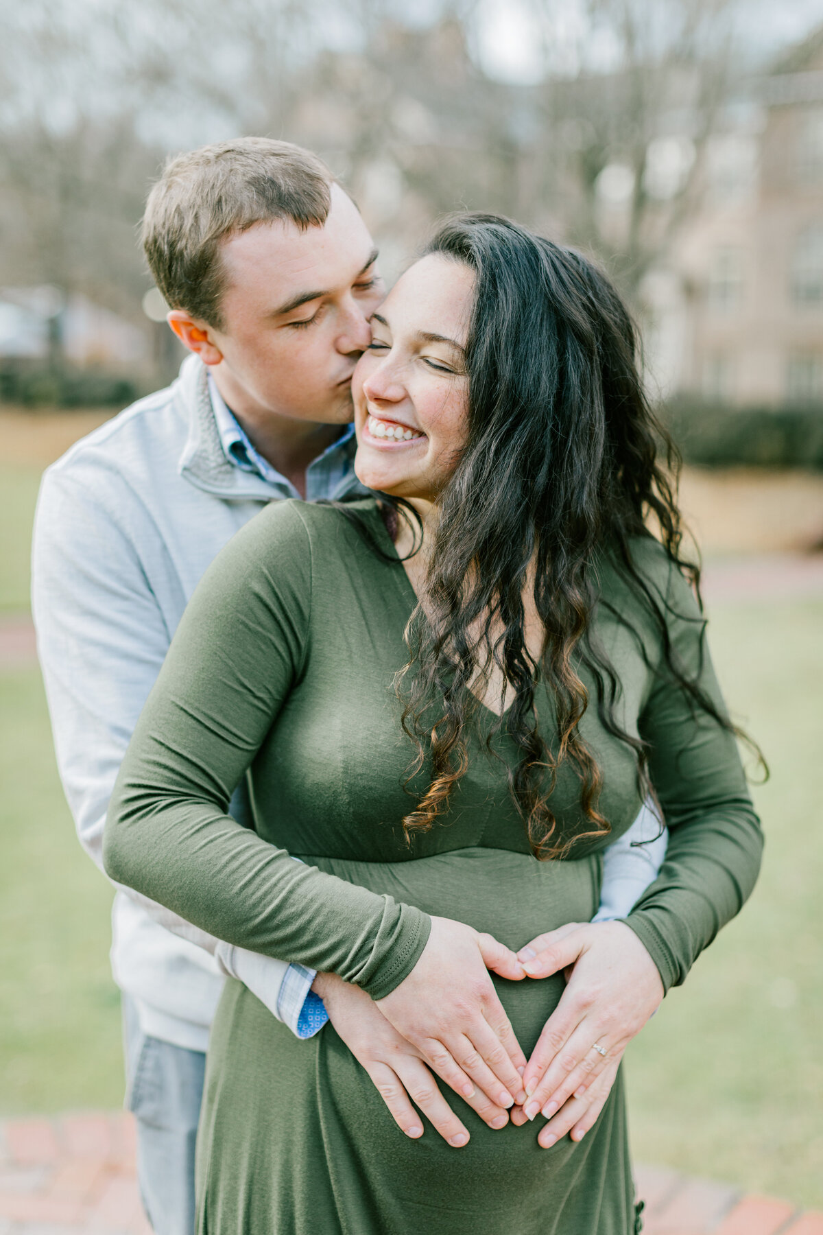 mom-laughing-holding-baby-bump-richmond-maternity-photo.jpg​