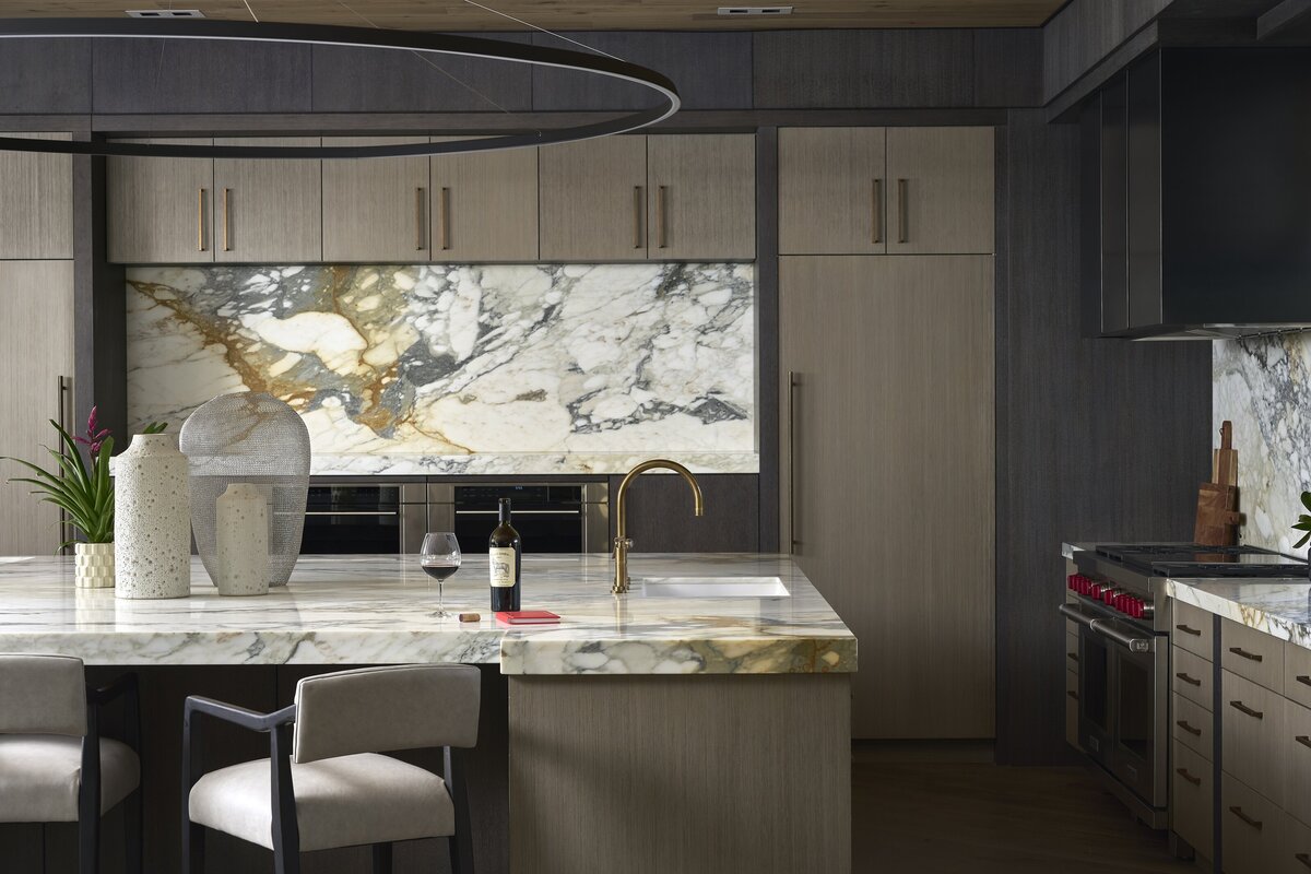 Moody kitchen with italian marble counters and rift oak cabinets designed by JSF Design