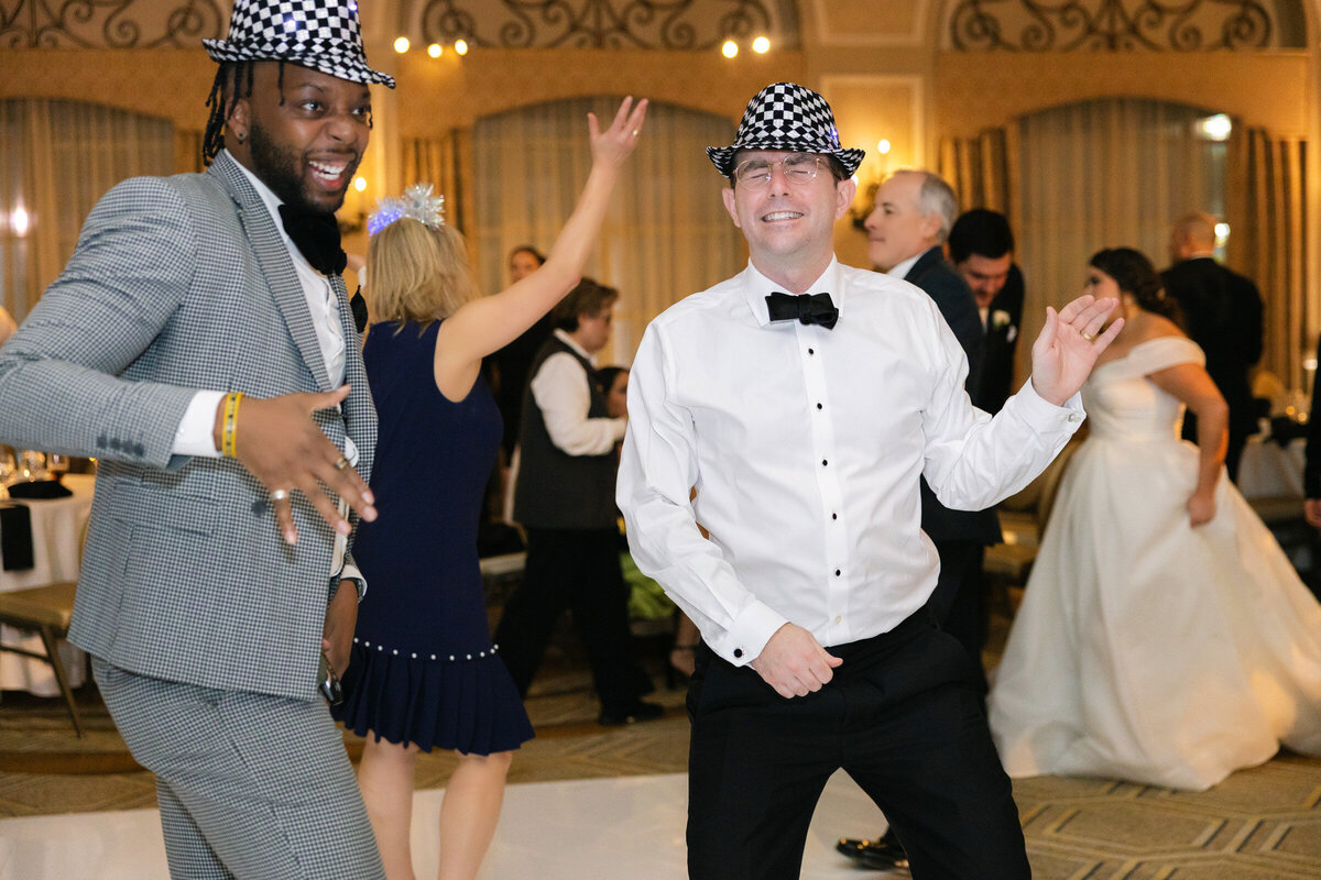 candid moment of guests dancing in fun hats at The Adolphus in Dallas