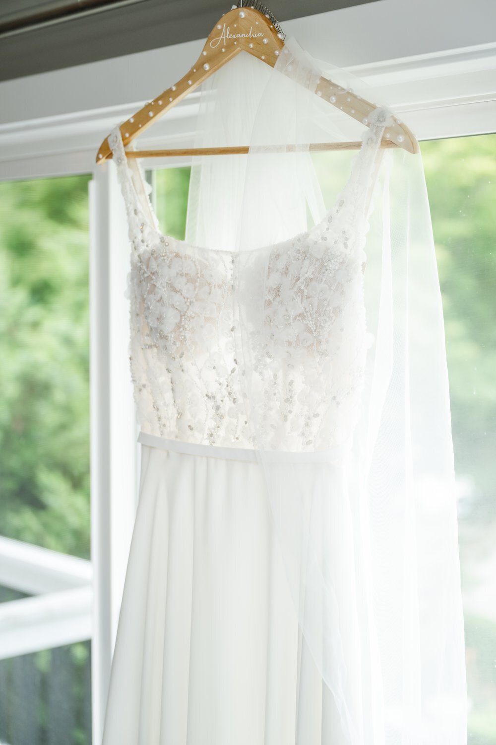 detail of white wedding dress with beading and sheer bodice