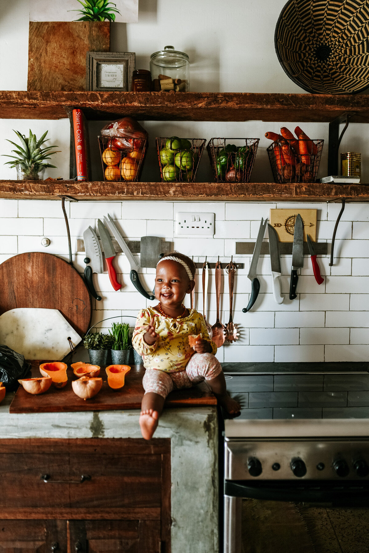 toddler on counter in kitchen for cute lifestyle photoshoot