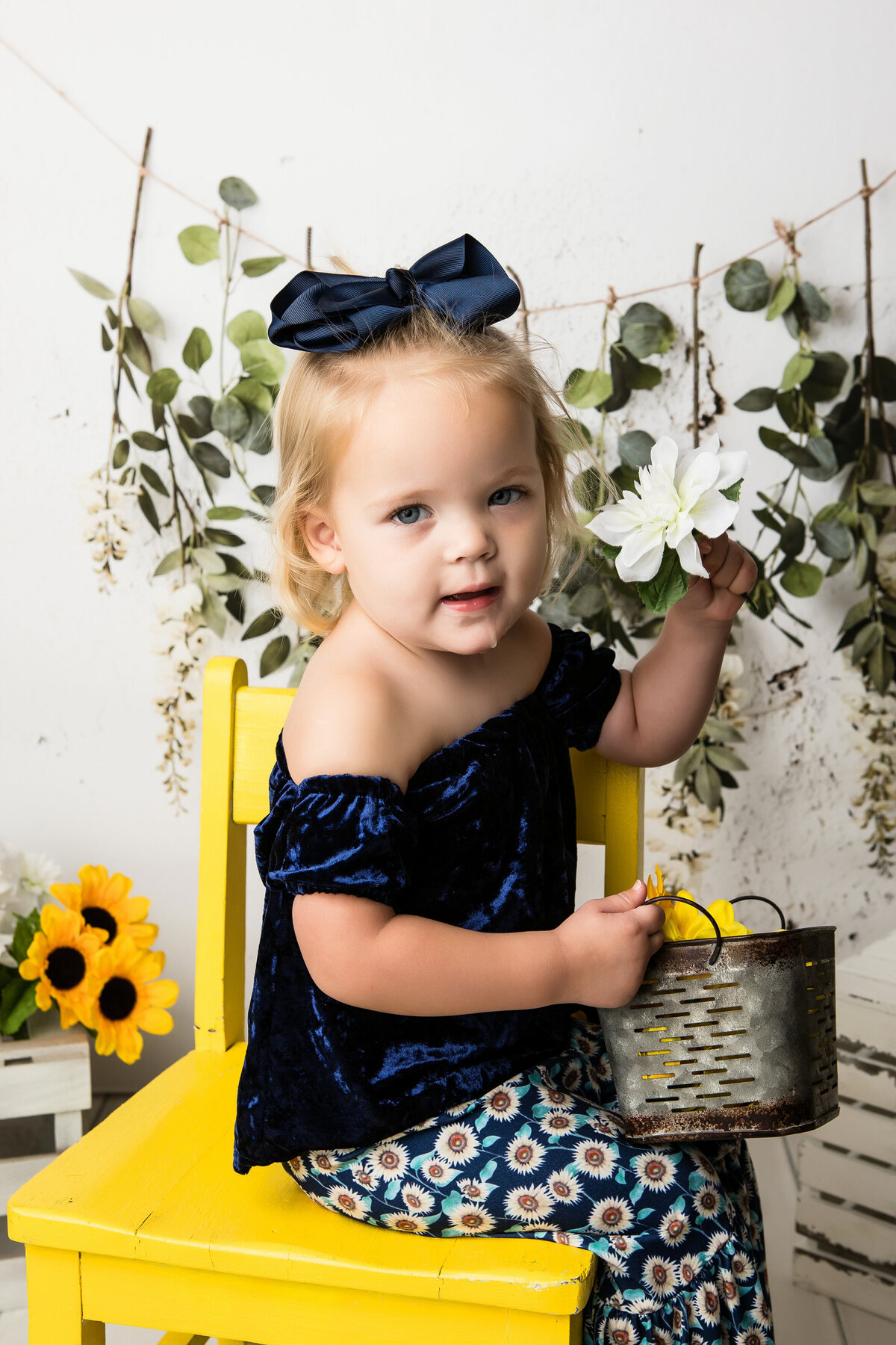 girl in studio with sunflowers