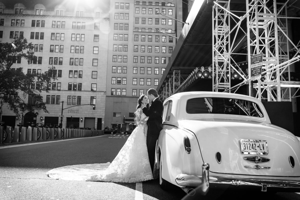 bride and groom beside a limo