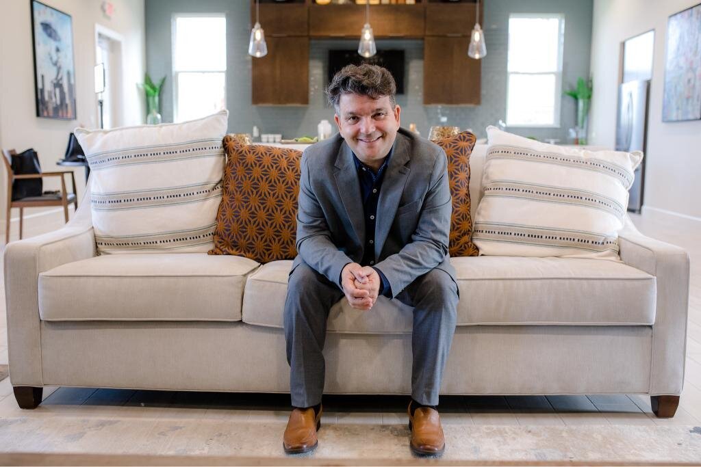 Salvatore relaxing on the sofa during a brand photo session great for home decor, style, and comfort content.