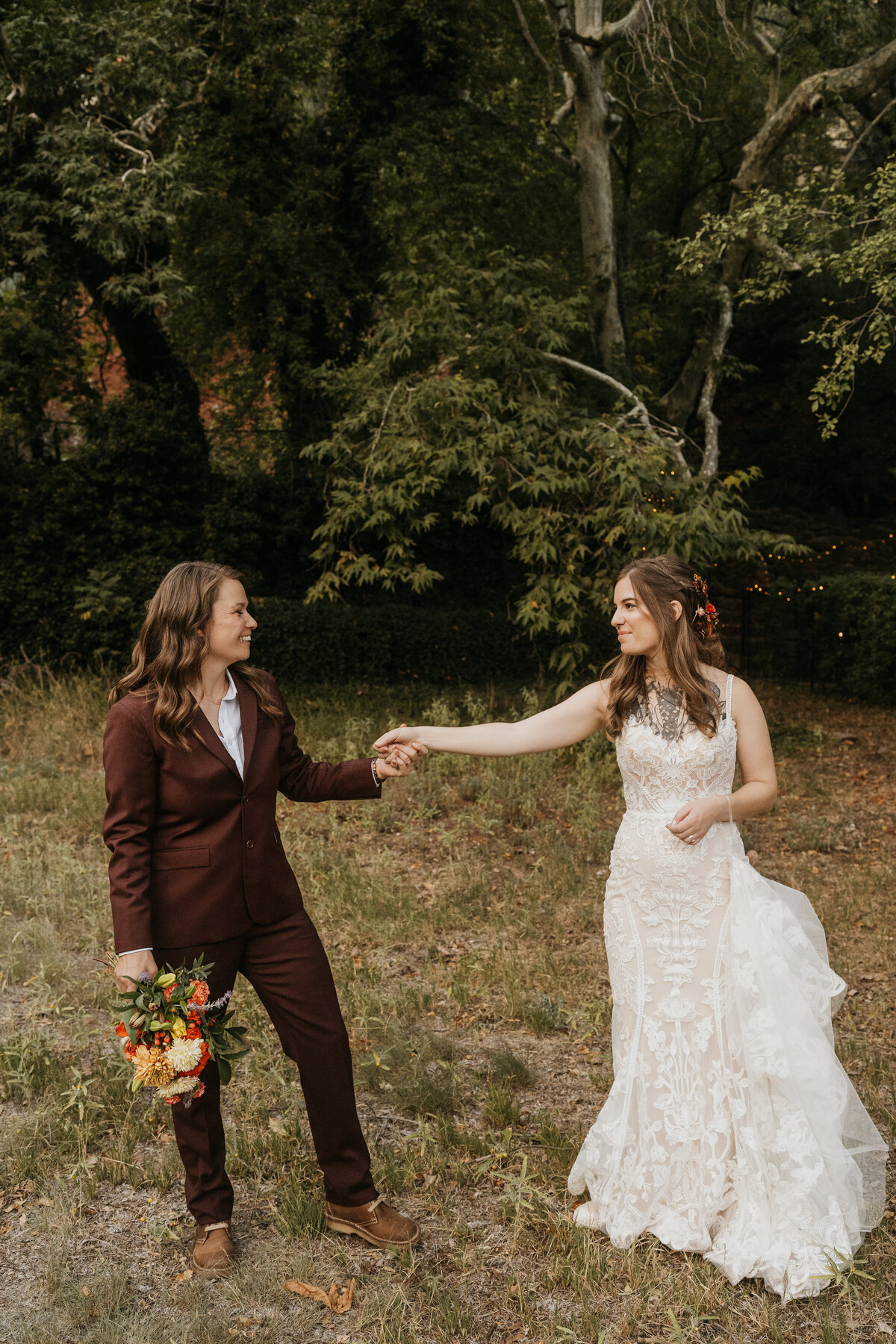 A newlywed couple reaching out with their fingers intertwined 