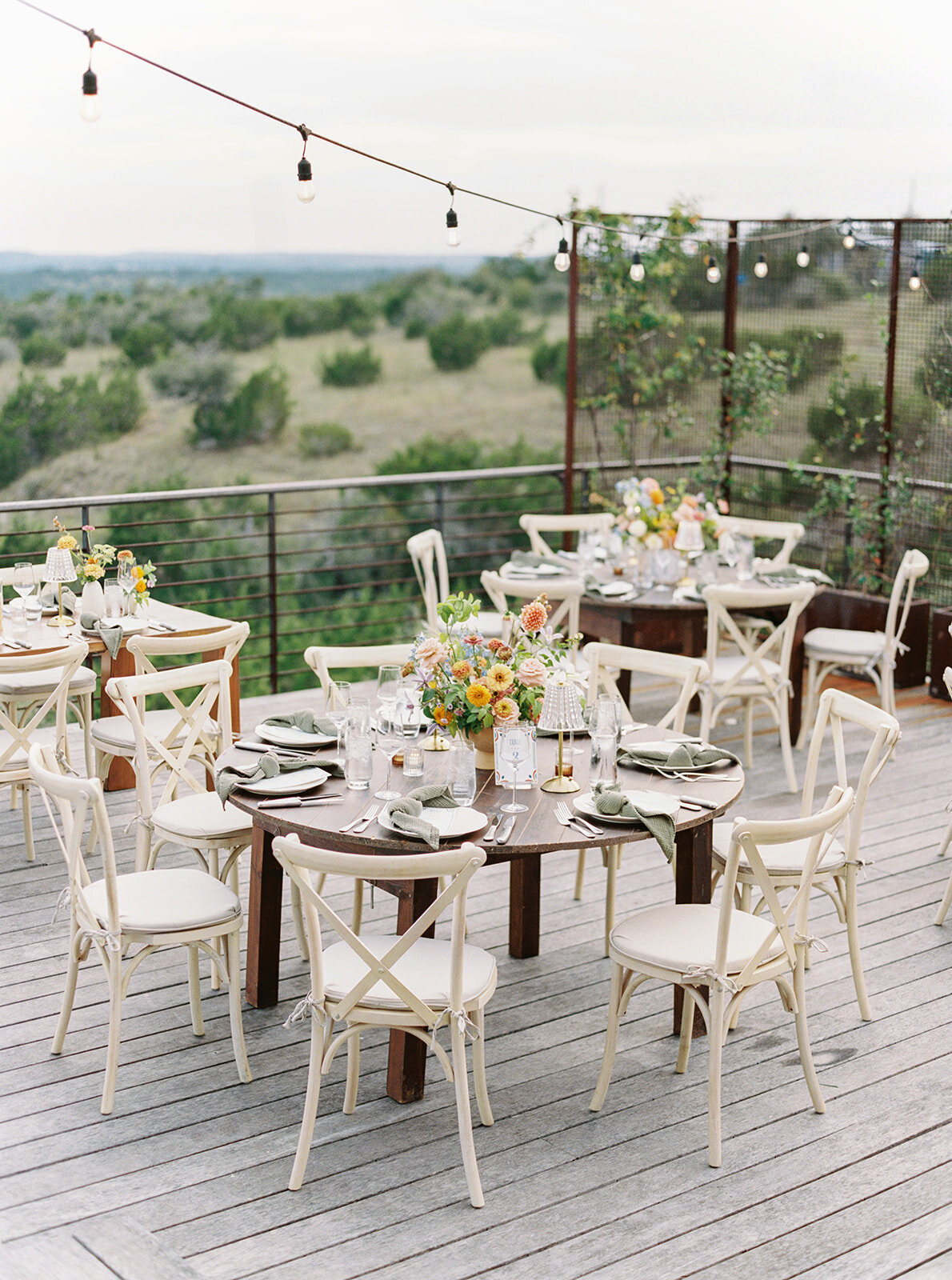 Colorful and Mexican inspired watercolor table numbers on wedding reception tables for Texas Hill Country wedding at Cactus Moon with floral arrangement by Lovelilly Floral and planning by Momentus Wed