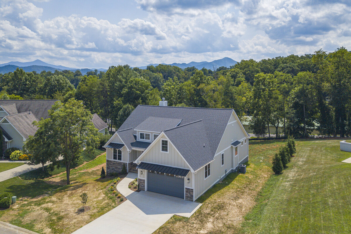 An aerial view of a home with a garage and driveway in Asheville NC