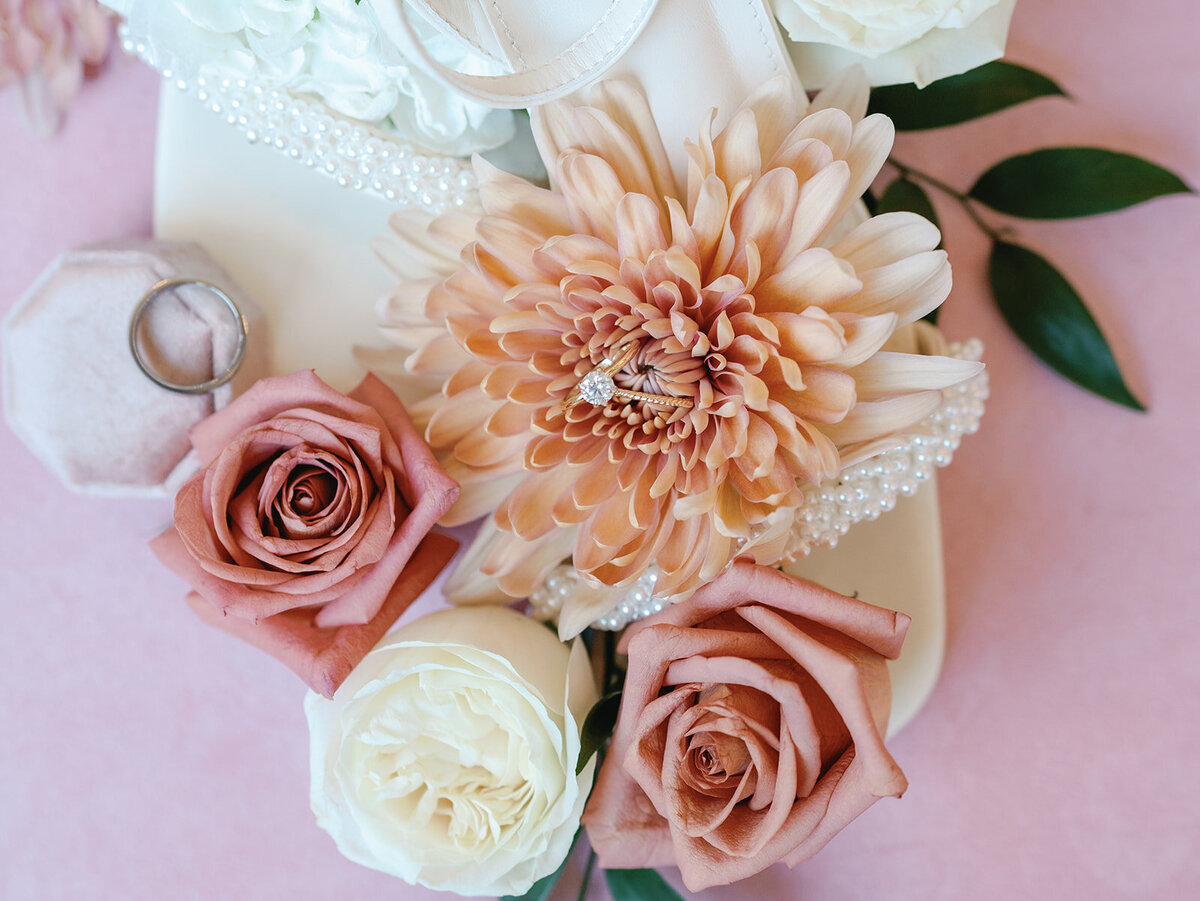 Detail of a dahlia and wedding rings