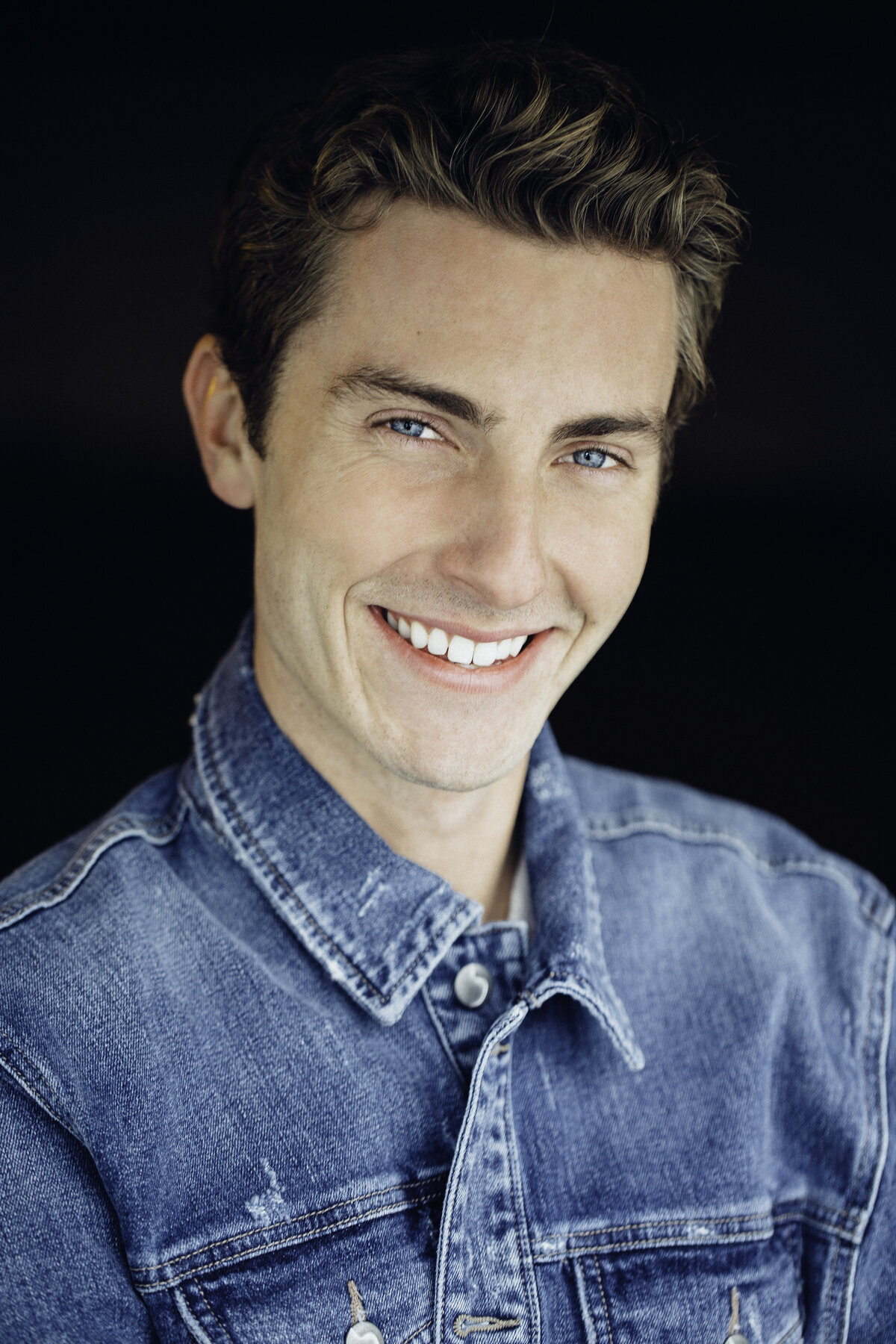 Headshot Photograph Of Young Man In Faded Blue Denim Jacket Los Angeles