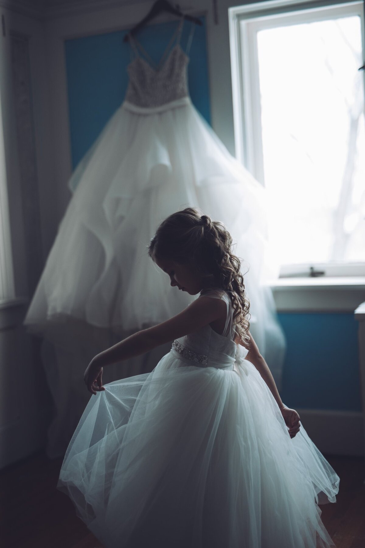 wedding-dress-flower-girl-in-front-of-window