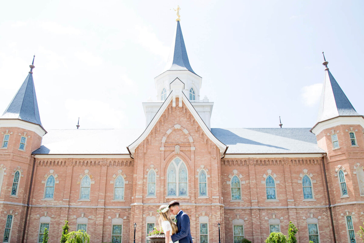 a wedding couple in front of a brick building