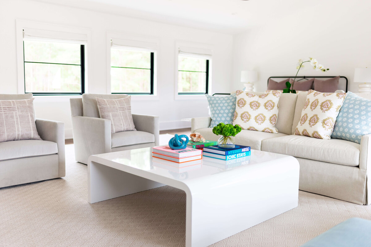 oyster creek studios building belt new build two gray arm cahirs and sofa with white coffee table in living room