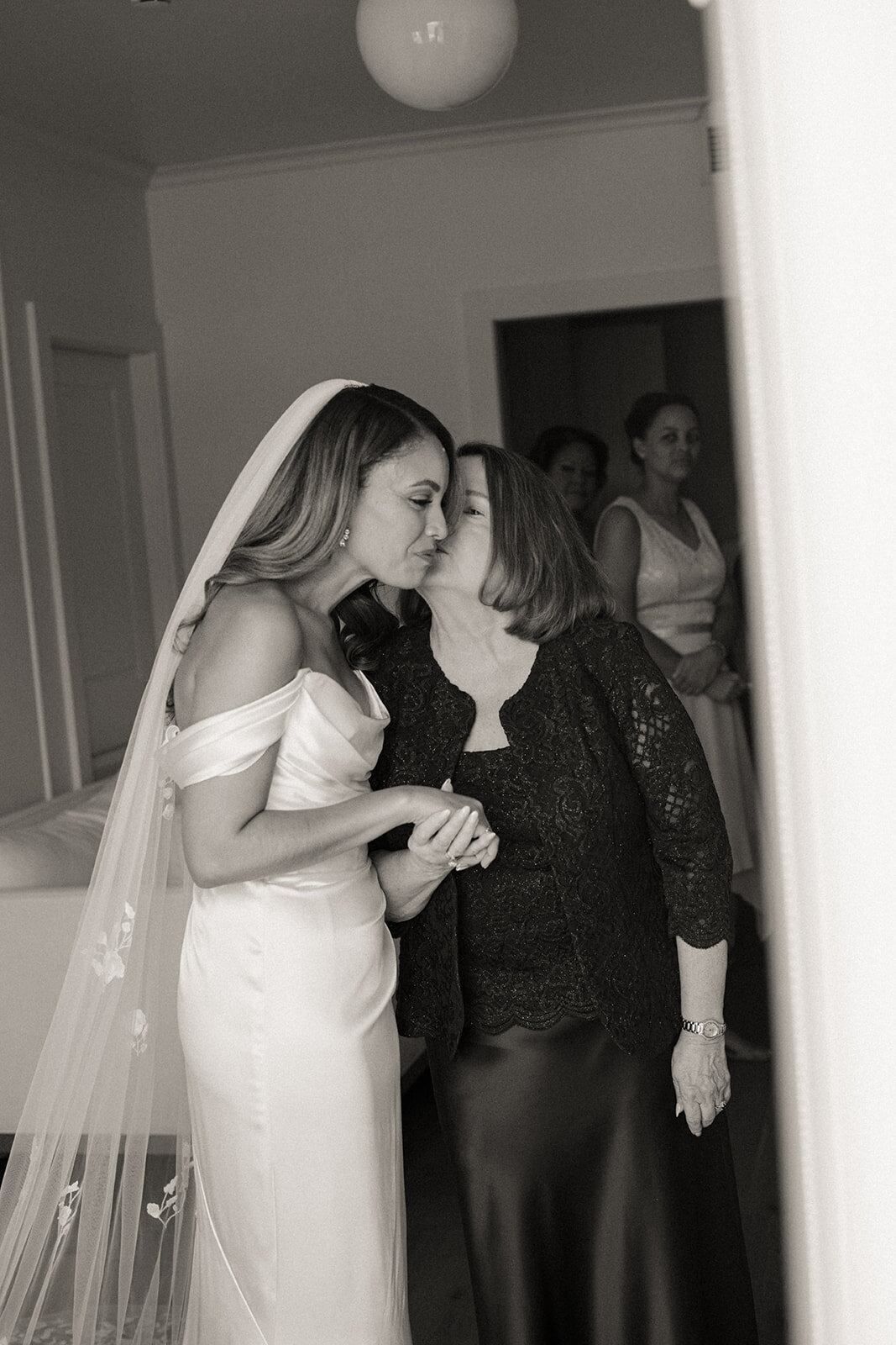 Bride and her mother share a moment getting ready at The Lake House on Canandaigua