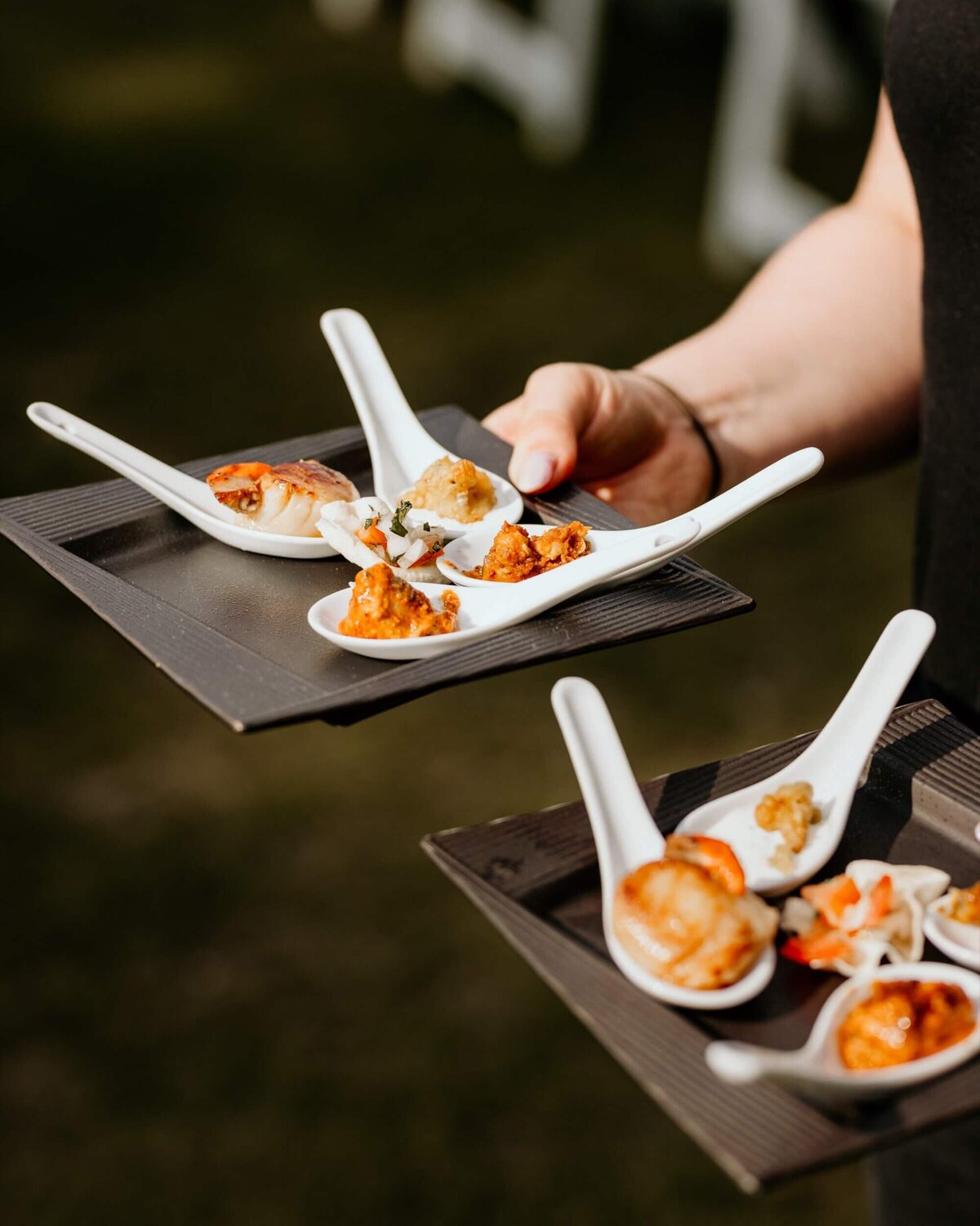 Canapes being served on china spoons