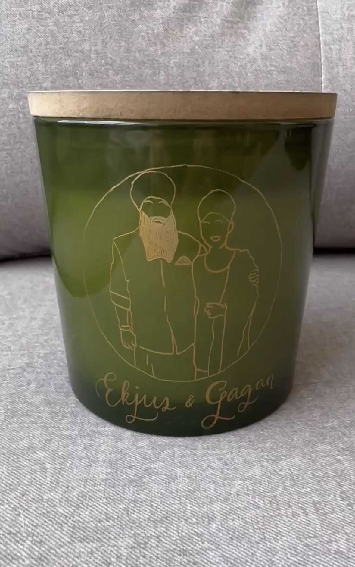 Bespoke engraving on a candle featuring line illustration of a Sikh couple by Toronto engraver Jenny Zhang