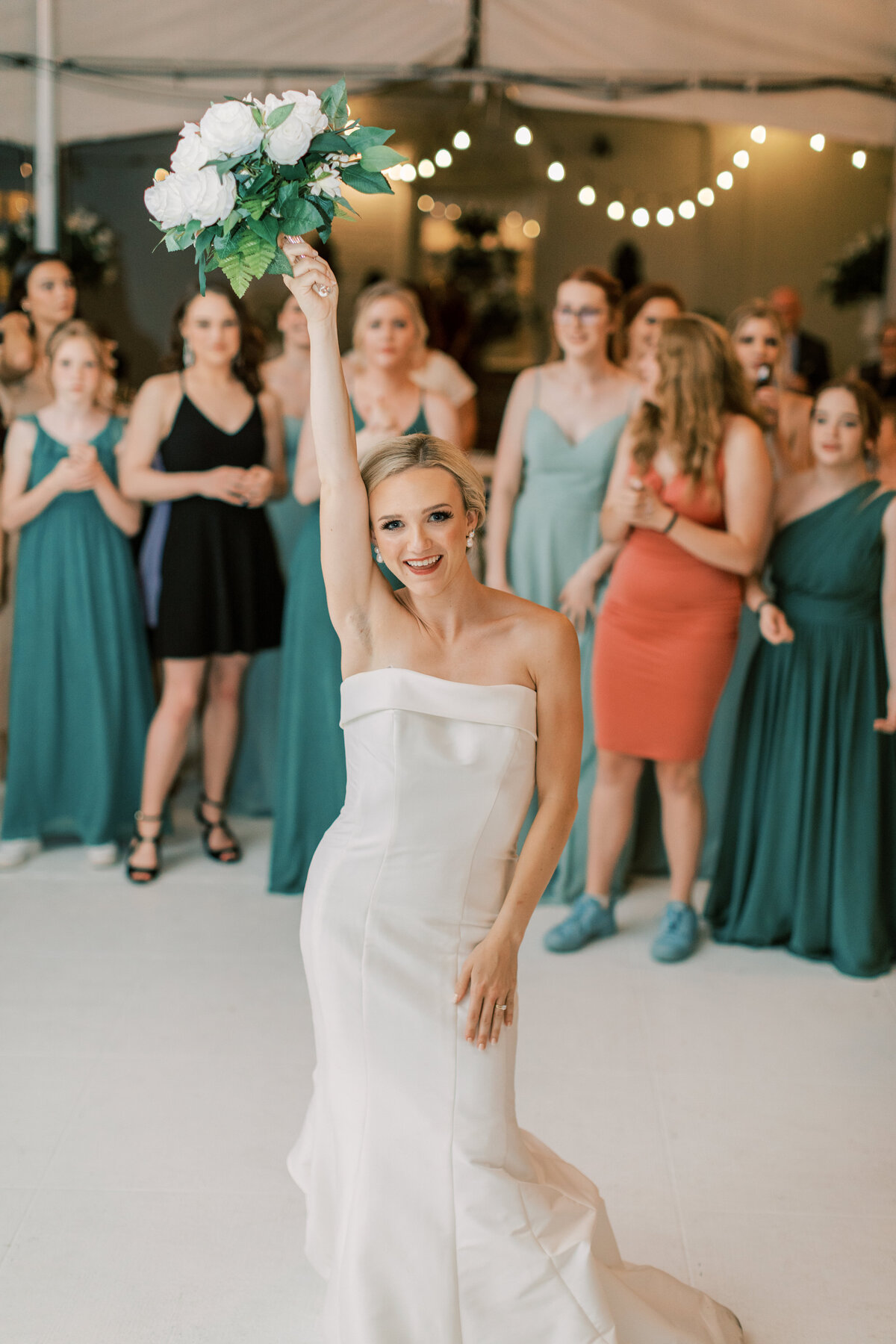 A bride throws her bouquet to the single ladies.