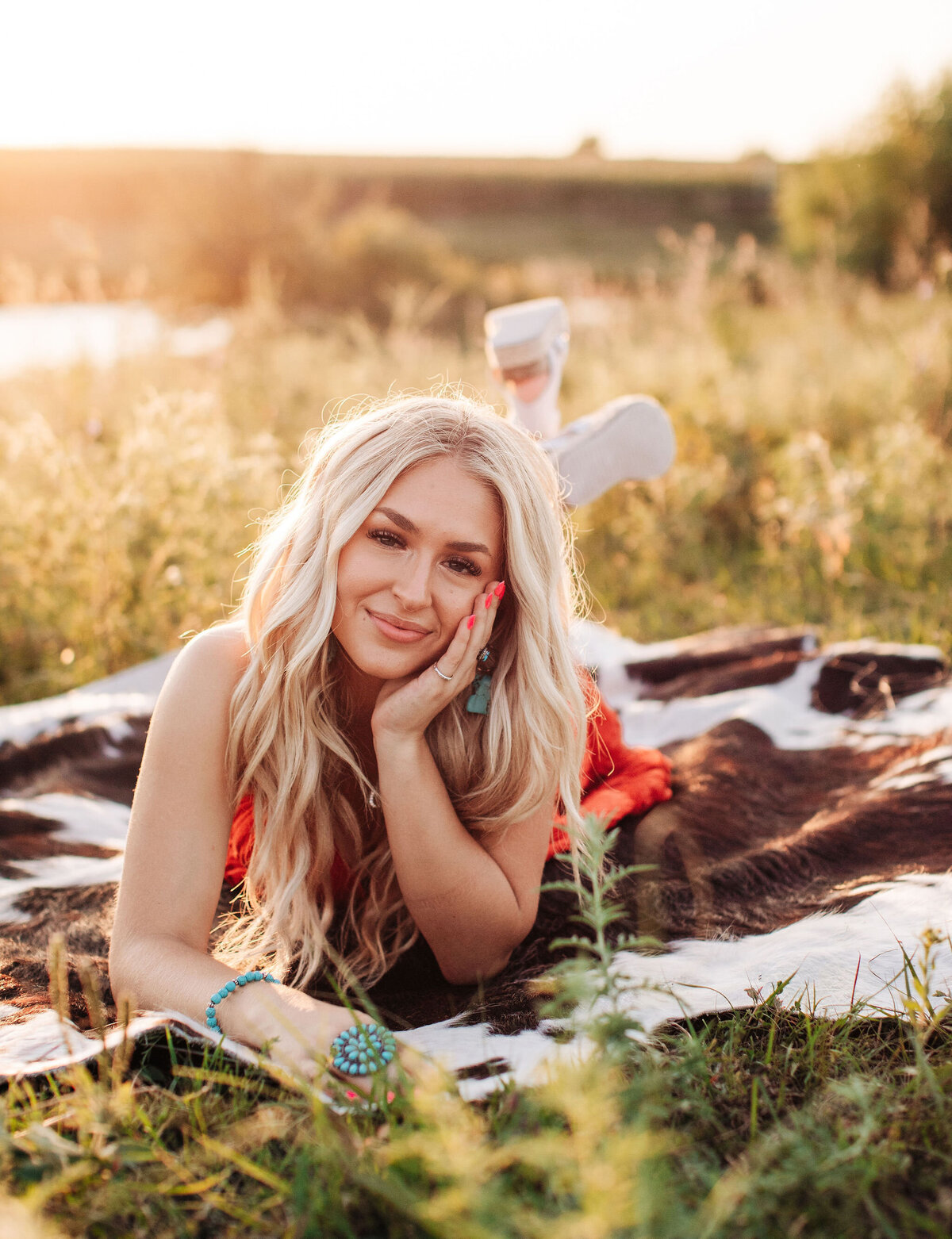 blonde girl laying on cowhide