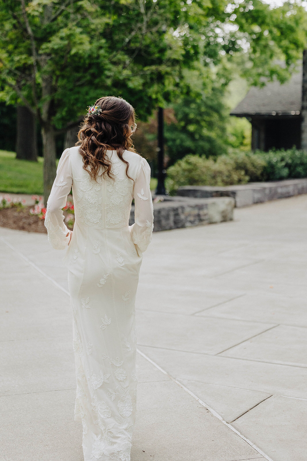 Bride walking through the grounds of Cornell University