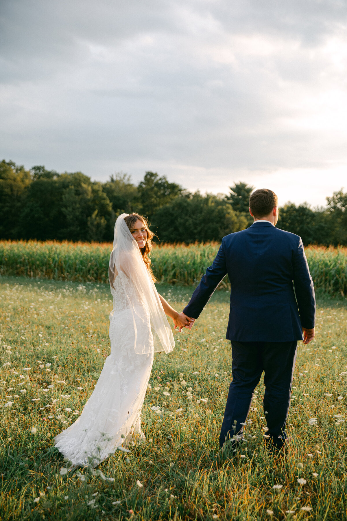 bride-groom-holding-hands-walking-away