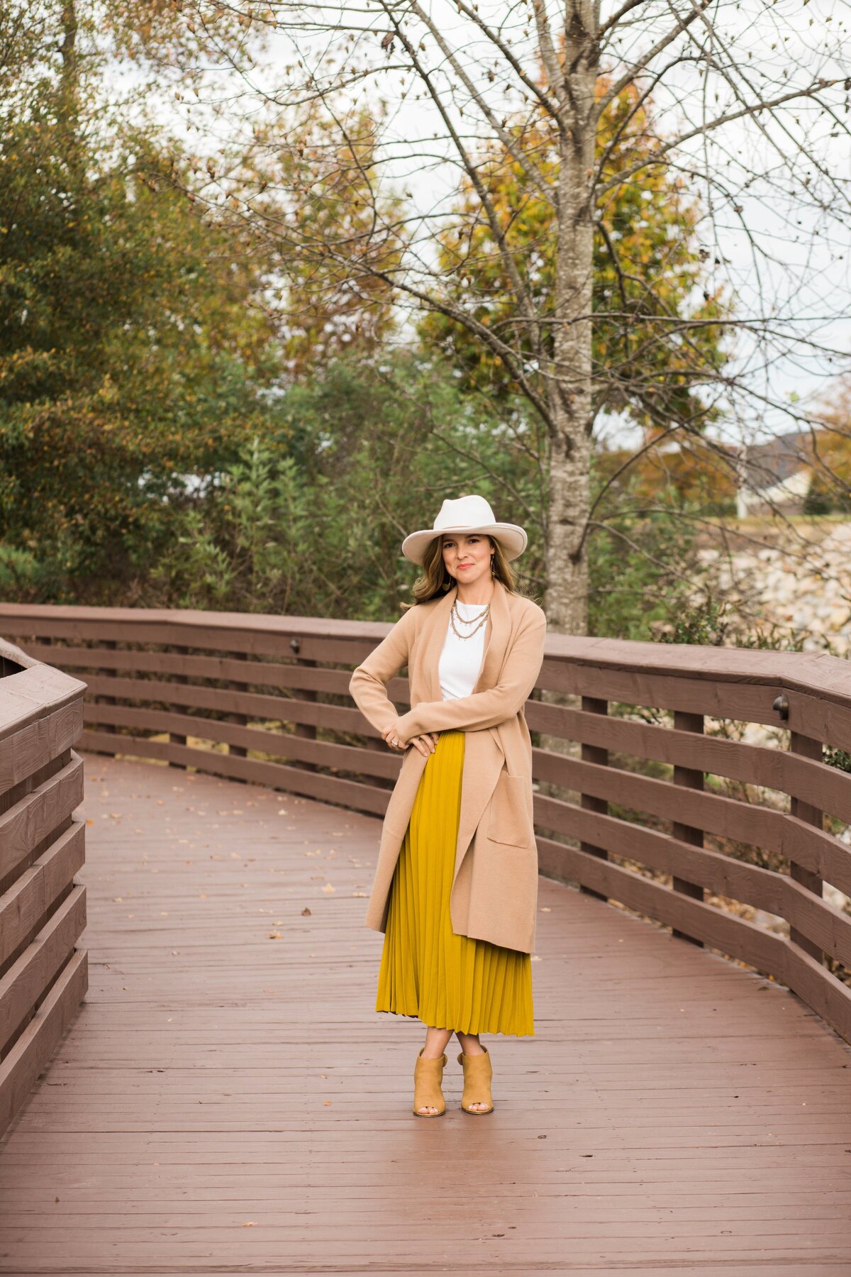 woman in yellow dress on a brown bridge