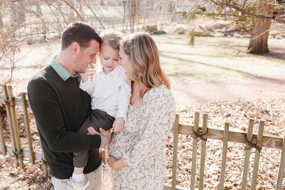 maternityfamilywithsonsmilingatbelly