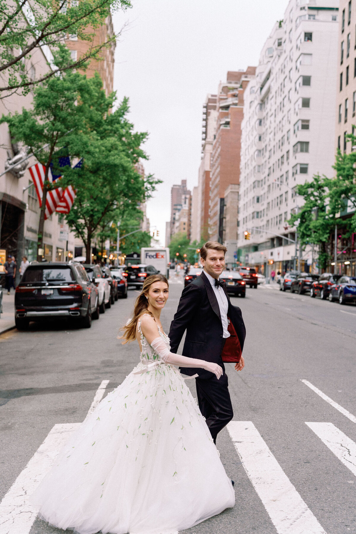 erica-renee-beauty-hair-and-makeup-duo-traveling-team-NYC-bride-street-shot-crosswalk-carlyle-hotel-NYC-over-the-moon-bride-couple-portrait-city-streets