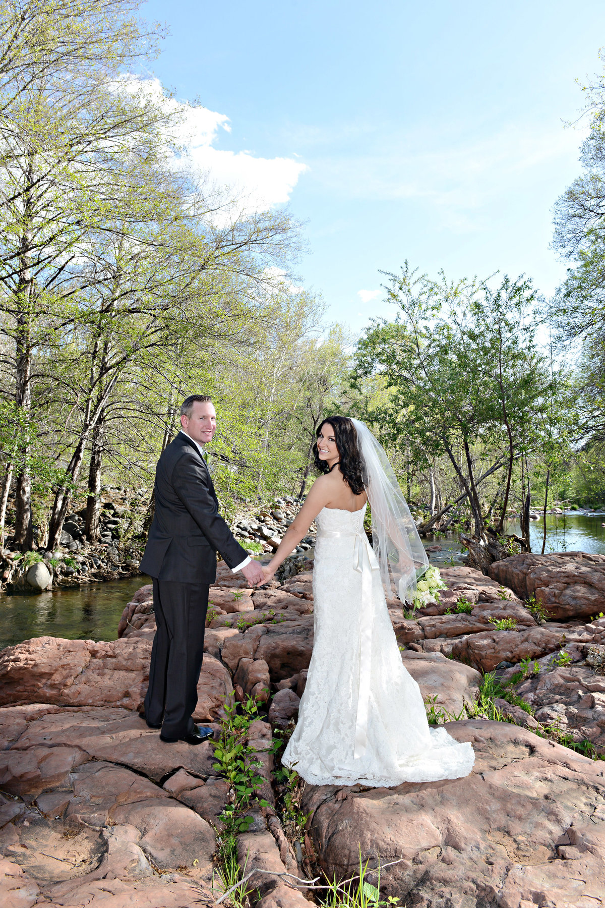 Bride and groom standing by a river in Sedona AZ