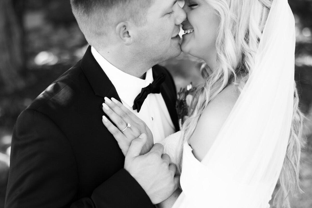 black and white close up of bride and groom kissing